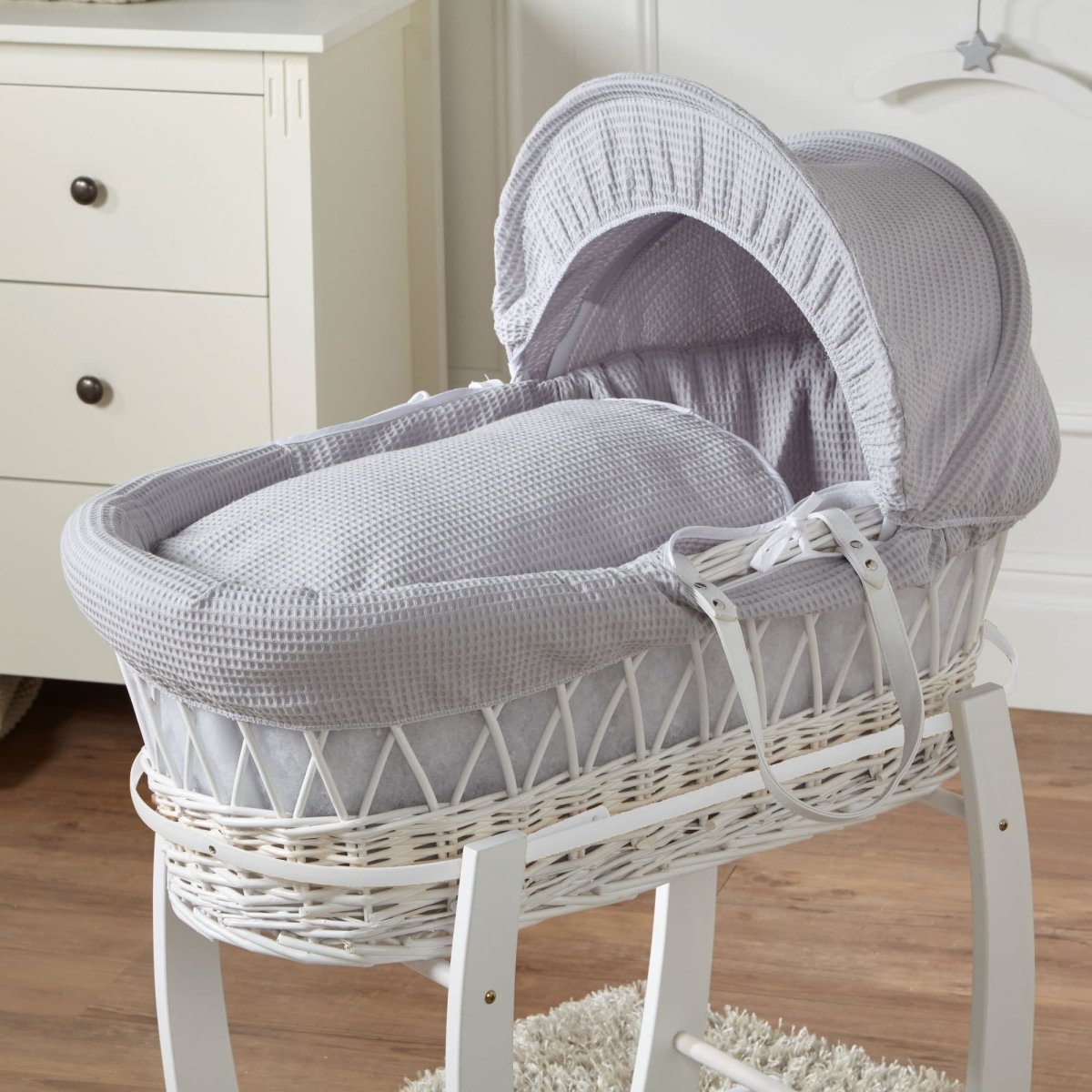 Wicker Moses basket with light grey cover and white waffle bedding, no stand