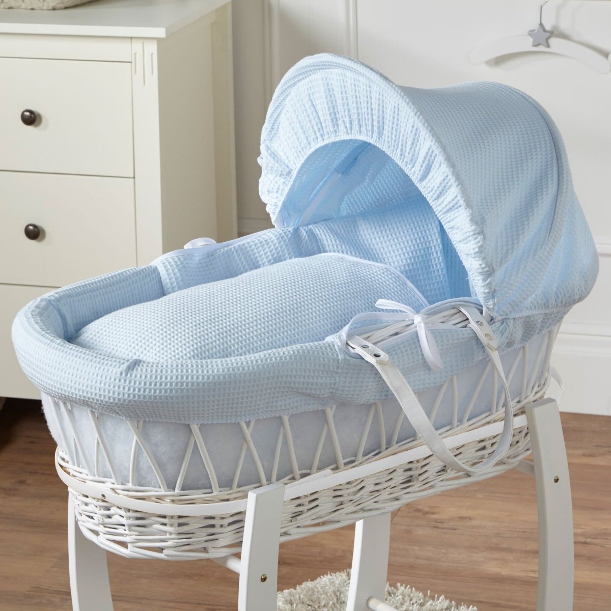 Light blue Moses basket with waffle bedding, curved hood and leather-look handle straps