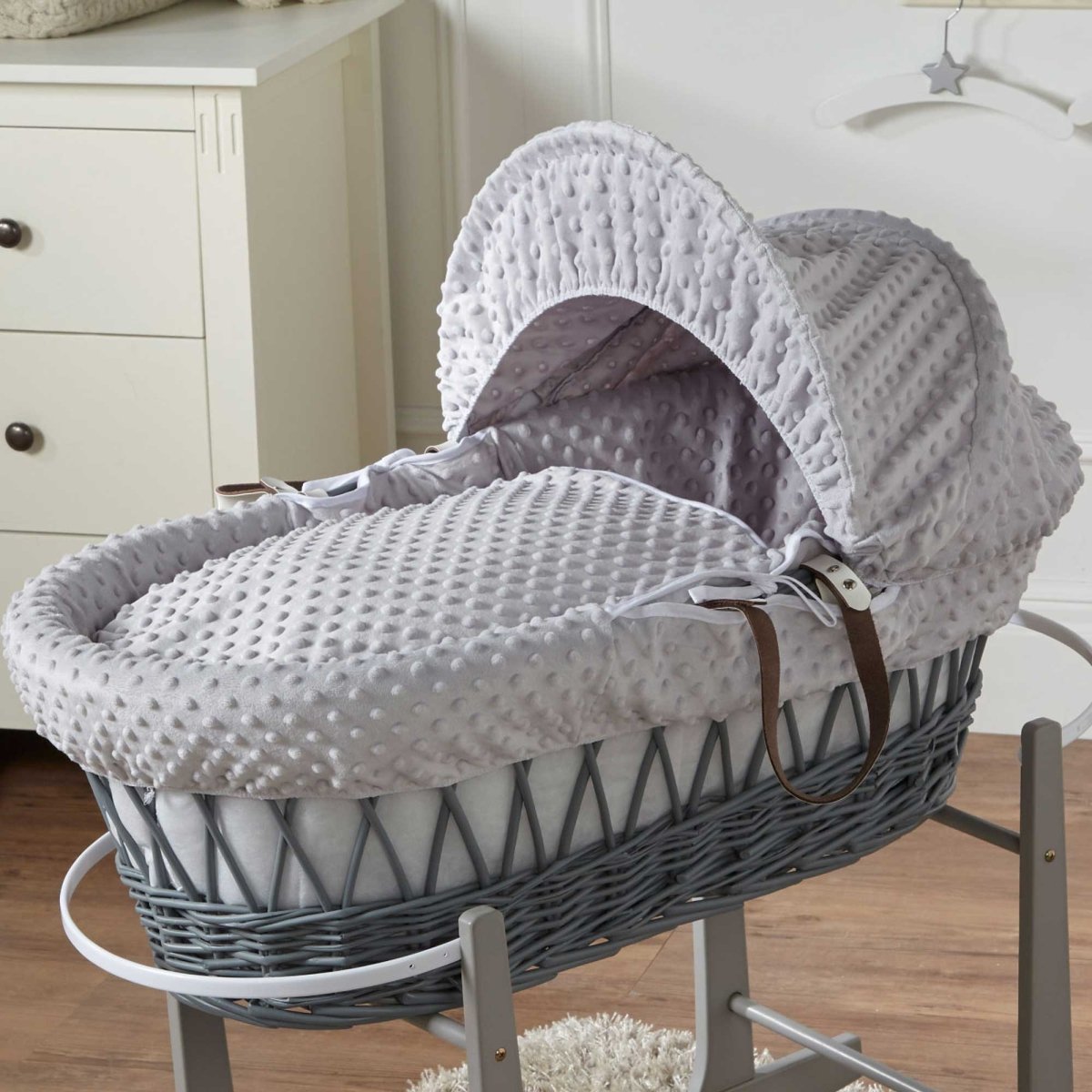 Wicker Moses basket with grey quilted bedding and white arched hood cover