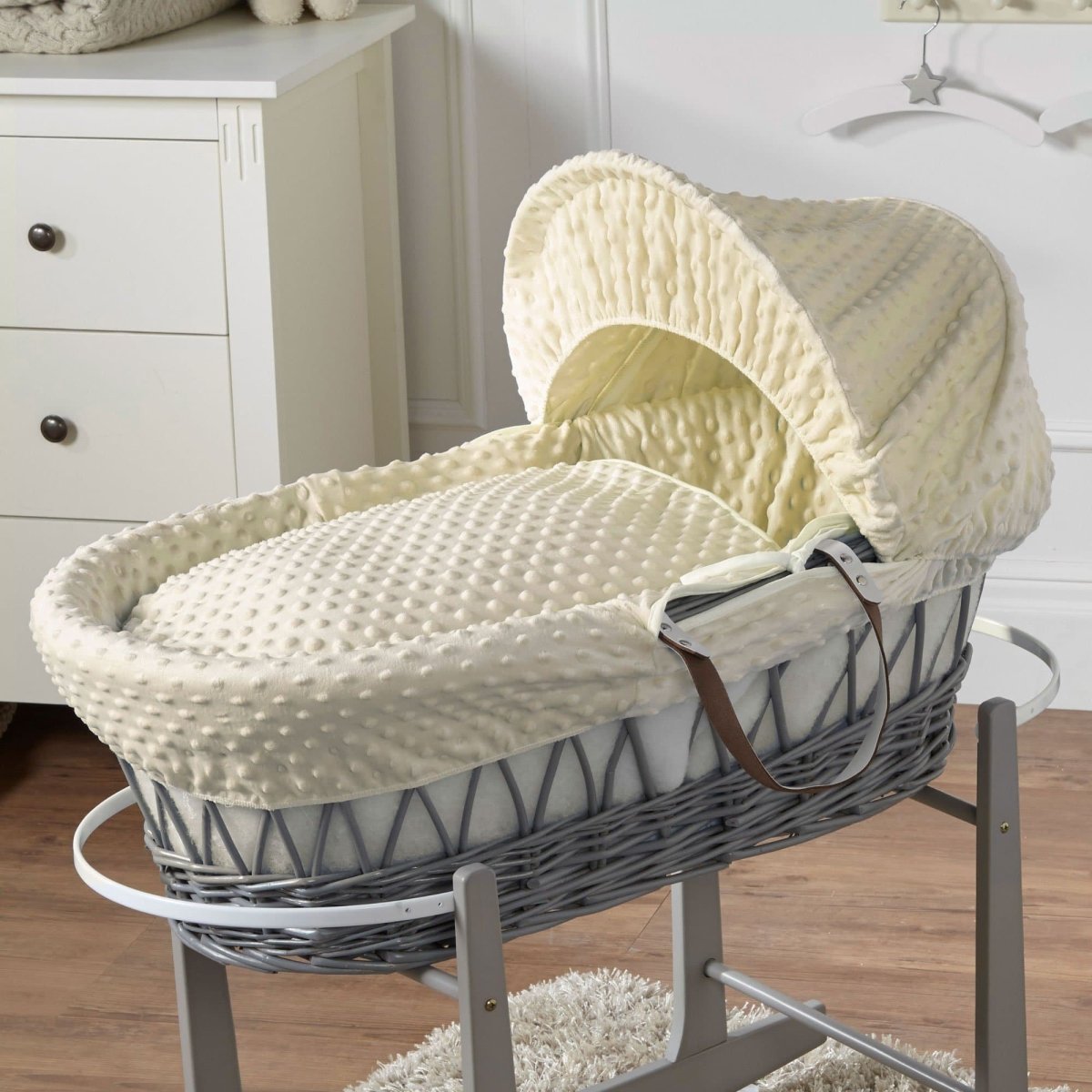 Wicker Moses basket with cream quilted bedding and raised hood cover