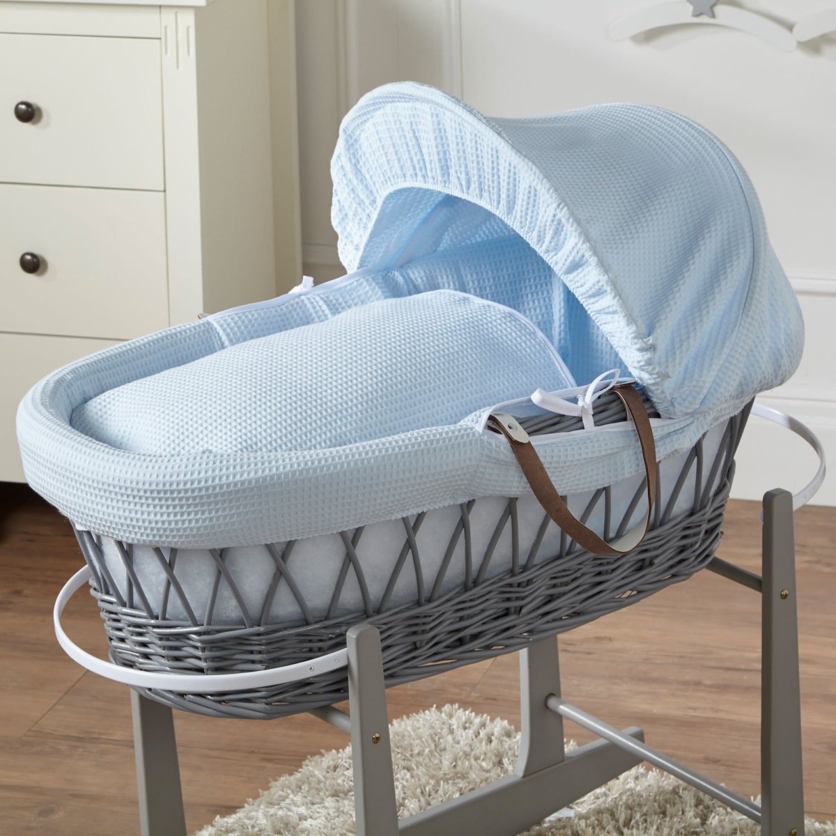 Wicker Moses basket with light blue waffle bedding and light grey frame, no stand