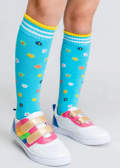 Knee-high blue socks with colorful floral pattern and striped ribbed cuffs